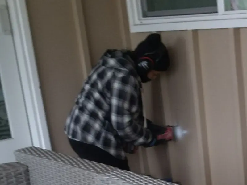 Professional electrician installing an exterior outlet in Covedale